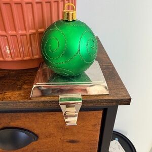 Three holiday decor, two stocking hangers and a small Santa